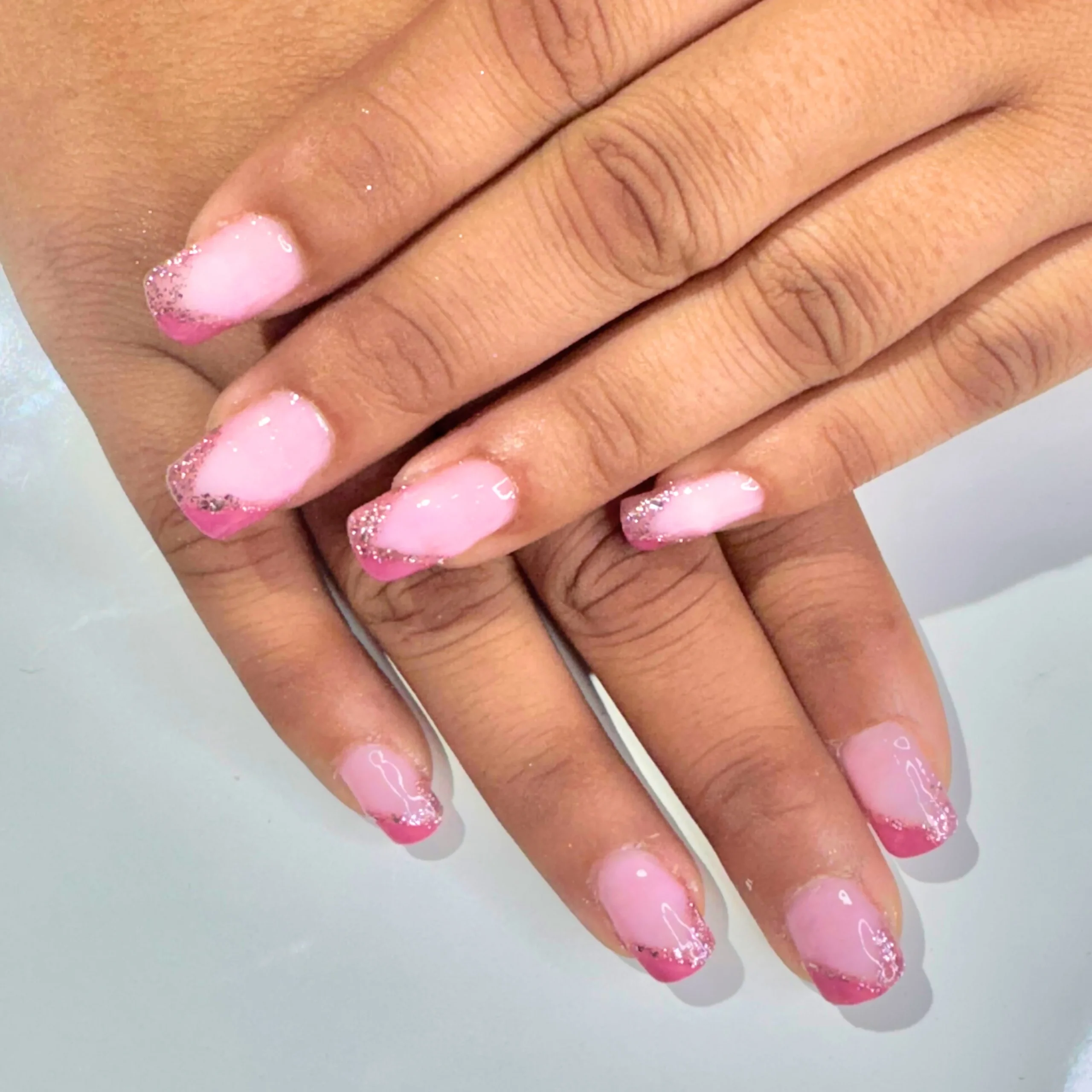 Elegant pink glitter French nail art design by Kashish Glam Makeover & Academy in Suratgarh